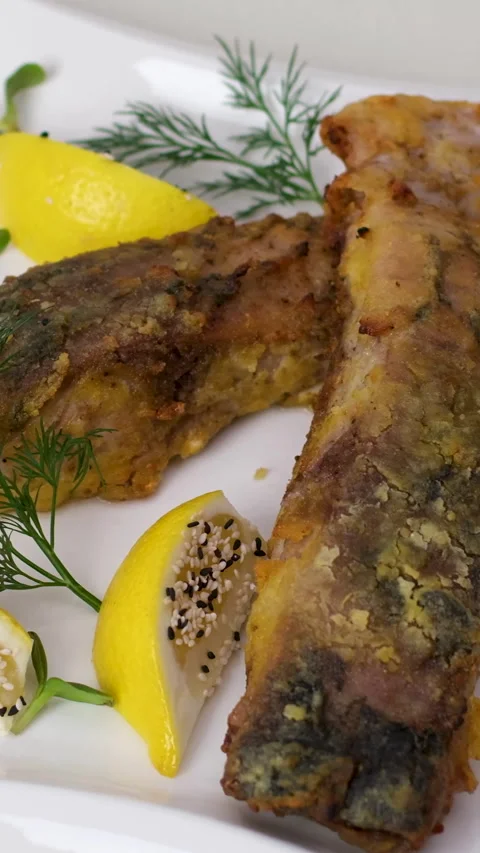Fried fish lemons breaded fish with dipping sauce and lemon Stock Footage 320401301
