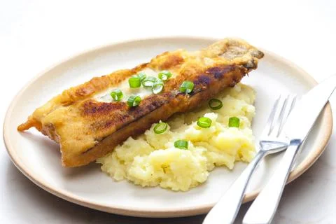 Fried fish with mashed potatoes and spring onion Stock Photos