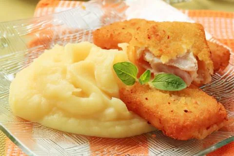 Fried fish with mashed potatoes and herbs Stock Photos