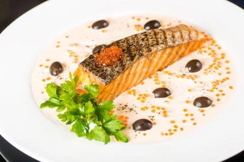 Fried fish with olives Stock Photos