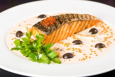 Fried fish with olives Stock Photos