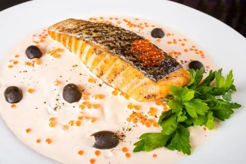 Fried fish with olives Stock Photos
