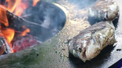 Fried fish on open flame. Fried Dorado fish Video stock 136324557