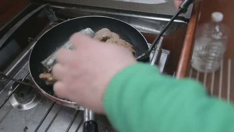 Fried fish on the paddle at the ship kitchen Stock Footage 74931870