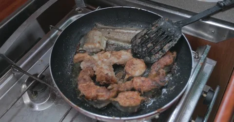 Fried fish on the pan at the ship Stock Footage 74109353
