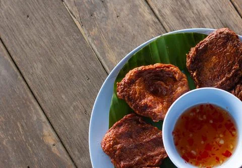 Fried fish paste balls or deep fried fish cake on wood table close up . Stock Photos