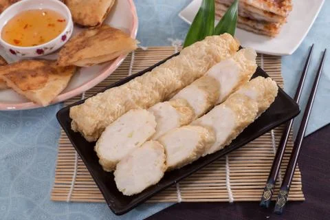 Fried fish paste on black plate on bamboo tray in restaurant Stock Photos