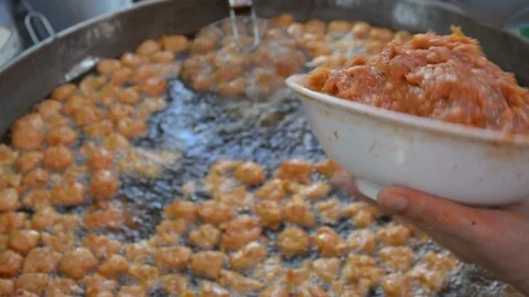 Fried fish patty is fried in boiling oil. Stock Footage 85901538