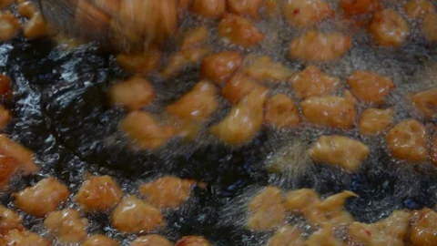 Fried fish patty is fried in boiling oil. Stock Footage 85921068