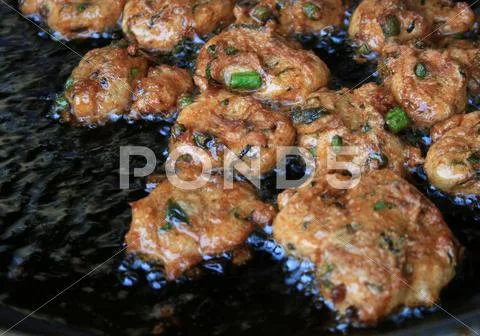 Fried fish patty is fried in boiling oil Stock Photos
