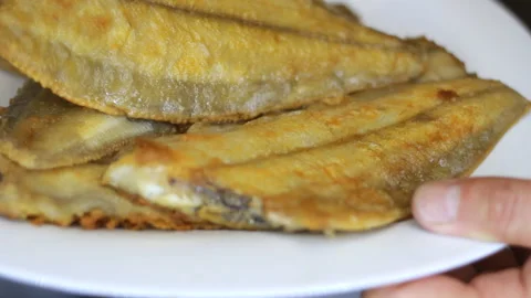 Fried fish on a plate close-up. Dorabo, sea bass, flounder Stock Footage 255841310