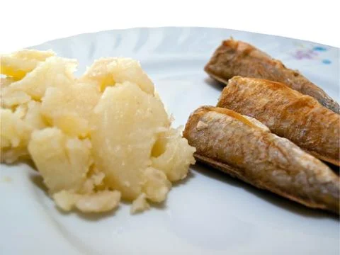 Fried fish with potatoes close up Stock Photos