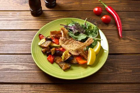 Fried Fish with Roasted Vegetables Stock Photos