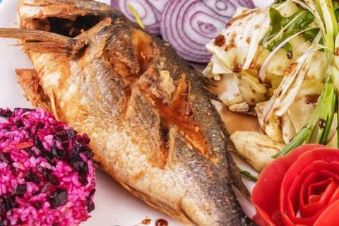 Fried fish served with vegetables Stock Photos