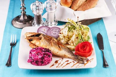 Fried fish served with vegetables Stock Photos