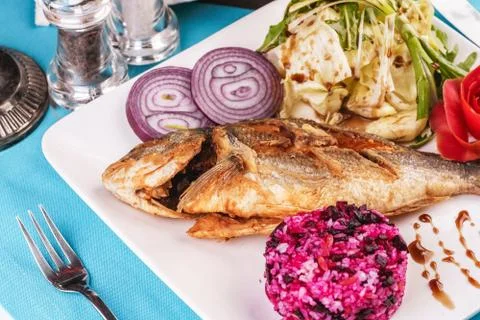 Fried fish served with vegetables Stock Photos