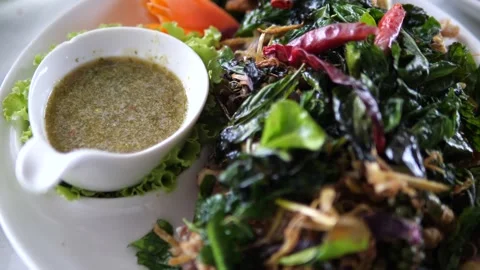 Fried fish topped with crispy Thai herbs served with spicy seafood dipping sauce Stock-Footage 332144792