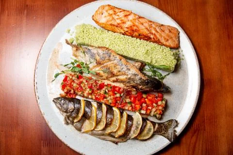 Fried fish with vegetable salad. Stock Photos