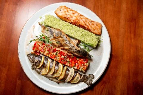 Fried fish with vegetable salad. Stock Photos