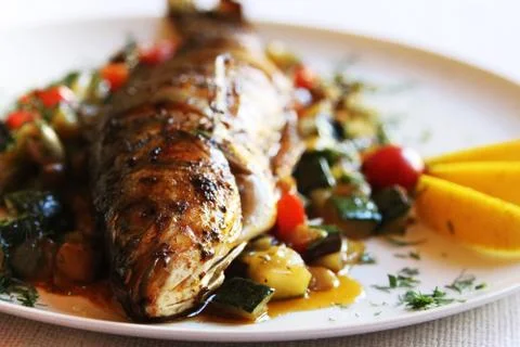 Fried fish with vegetables Stock Photos