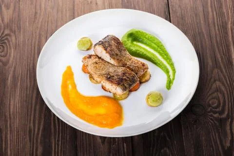 Fried fish with vegetables Stock Photos