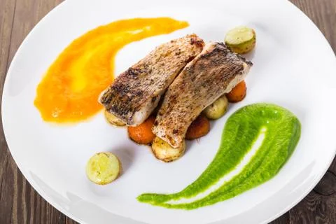 Fried fish with vegetables Stock Photos