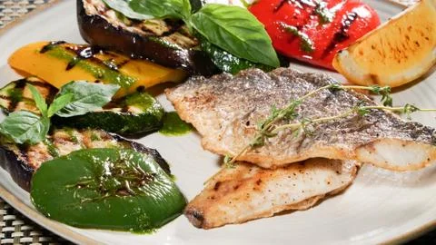 Fried fish with vegetables Stock Photos