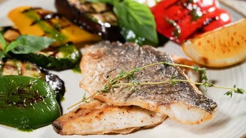 Fried fish with vegetables Stock Photos