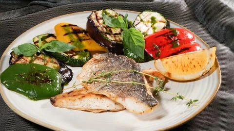 Fried fish with vegetables Stock Photos