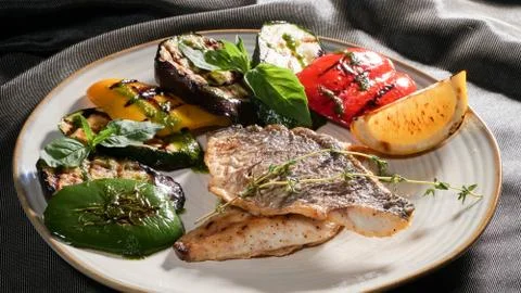 Fried fish with vegetables Stock Photos