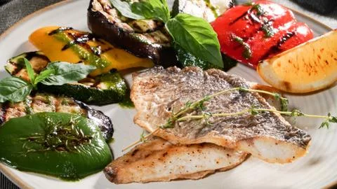 Fried fish with vegetables Stock Photos