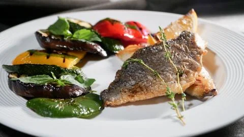 Fried fish with vegetables Stock Photos