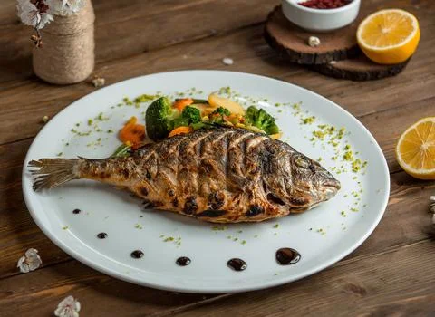 Fried fish with vegetables in the plate 3 写真素材