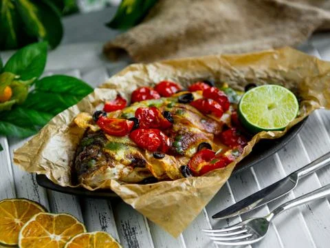 Fried fish with vegetables on the table Stock Photos