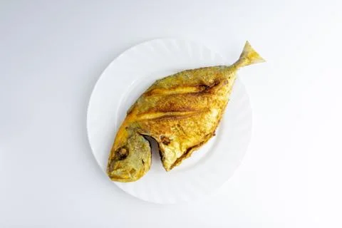 Fried fish on white background with selective focus Stock Photos