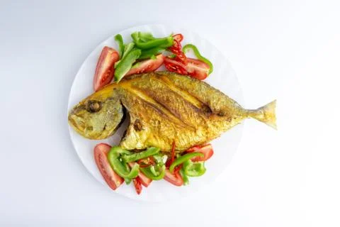 Fried fish on white background with selective focus Stock Photos