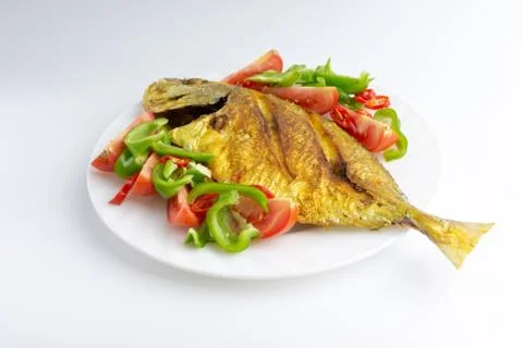 Fried fish on white background with selective focus Stock Photos
