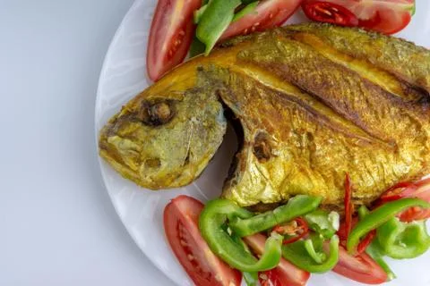 Fried fish on white background with selective focus Stock Photos