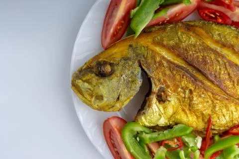 Fried fish on white background with selective focus Photos
