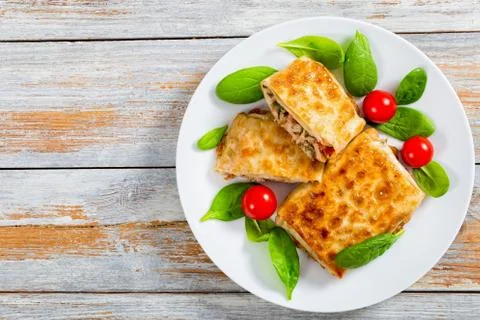 Fried flatbread wraps Stuffed with meat on white dish Stock Photos