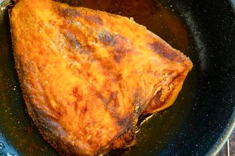 Fried flounder. Home cooking in a rustic style. Stock Photos