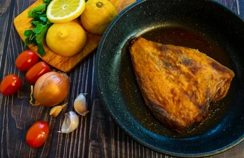 Fried flounder. Home cooking in a rustic style. Stock Photos
