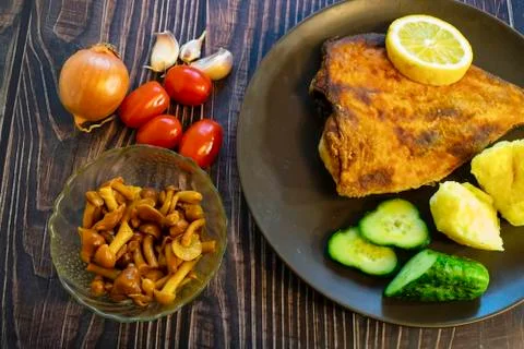Fried flounder. Home cooking in a rustic style. Stock Photos