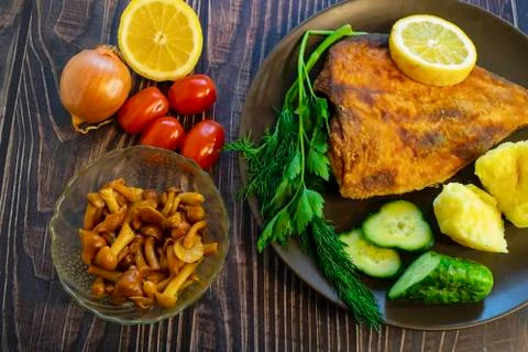 Fried flounder. Home cooking in a rustic style. Stock Photos