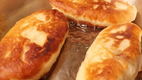 Fried flour pie in a pan. Dough pies, home cooking. Making dough pies, frying Stock Footage 318919725