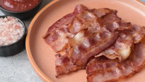 Fried fresh bacon slices with layers of meat or prosciutto with salt and spices. Stock-Footage 335377666