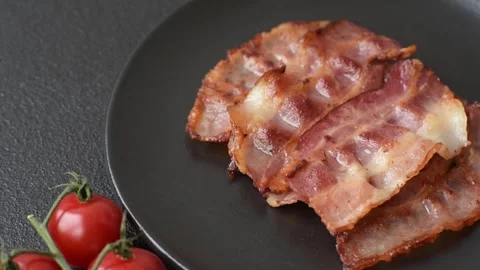 Fried fresh bacon slices with layers of meat or prosciutto with salt and spices. Stock-Footage 335377751