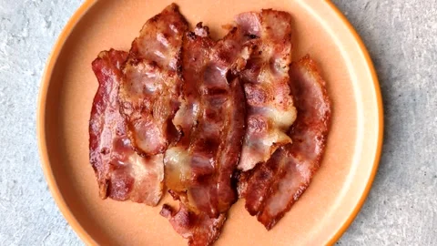 Fried fresh bacon slices with layers of meat or prosciutto with salt and spices. Stock-Footage 335377927