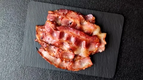 Fried fresh bacon slices with layers of meat or prosciutto with salt and spices. Stock-Footage 335377958