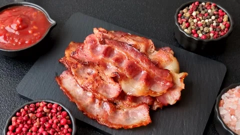 Fried fresh bacon slices with layers of meat or prosciutto with salt and spices. Stock-Footage 335377976